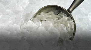 Scoop in crushed ice with metal spoon.