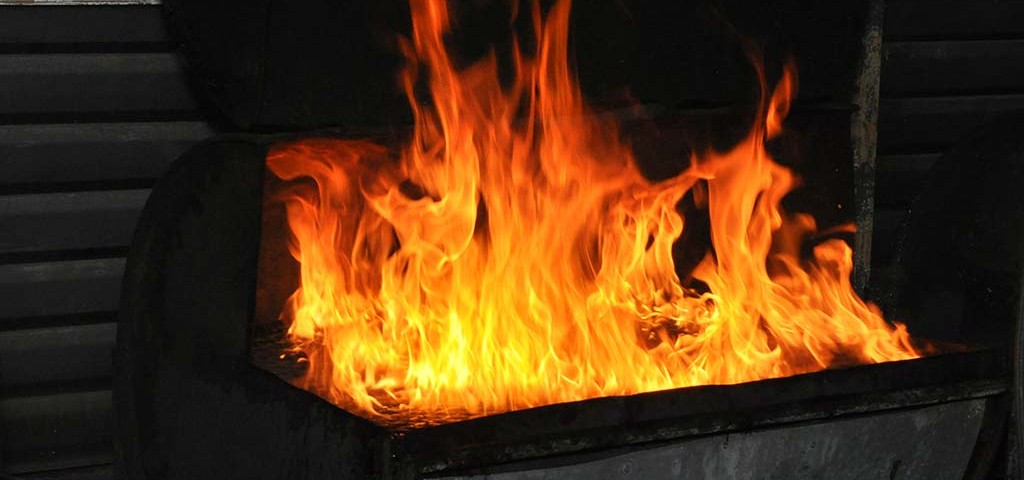 flaming charcoal grill at trellis bay market grill