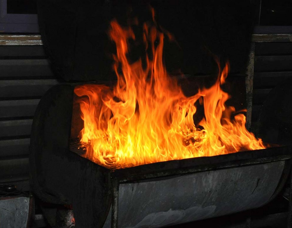 flaming charcoal grill at trellis bay market grill