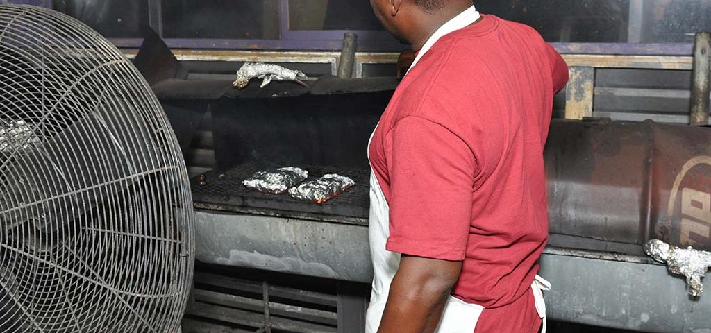 One of the cooks grilling chicken