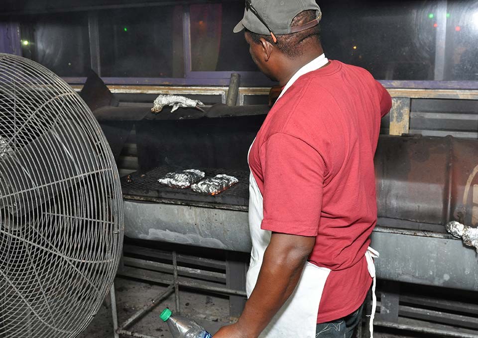One of the cooks grilling chicken