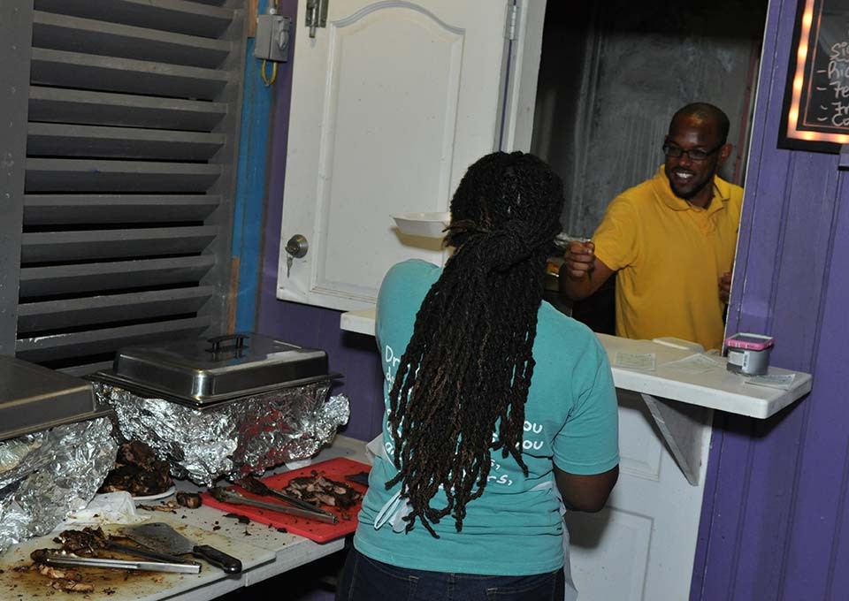 workers at trellis bay market exchanging smiles