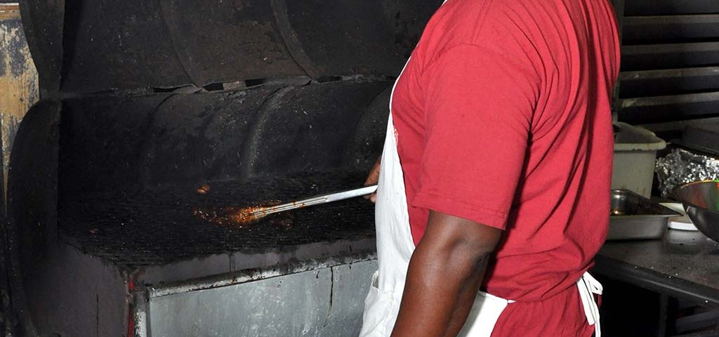 chef peter preparing is flaming grill at trellis bay market