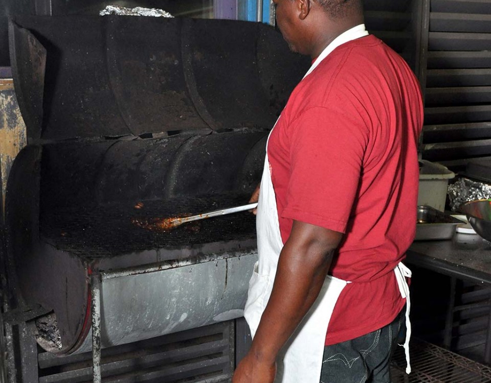 chef peter preparing is flaming grill at trellis bay market