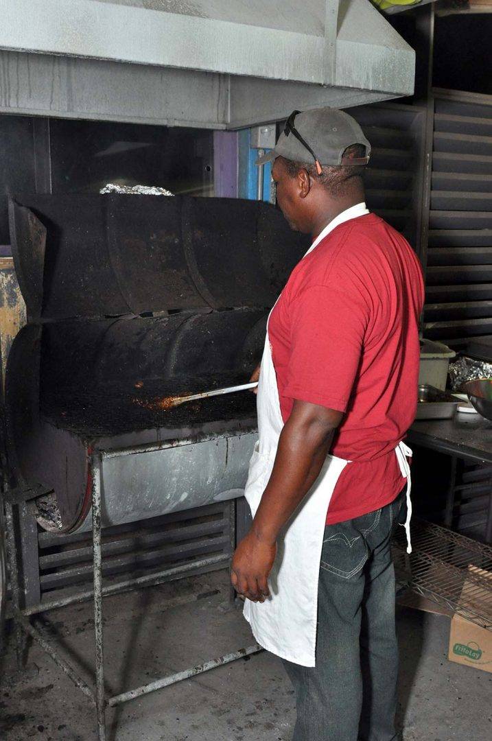 chef peter preparing is flaming grill at trellis bay market