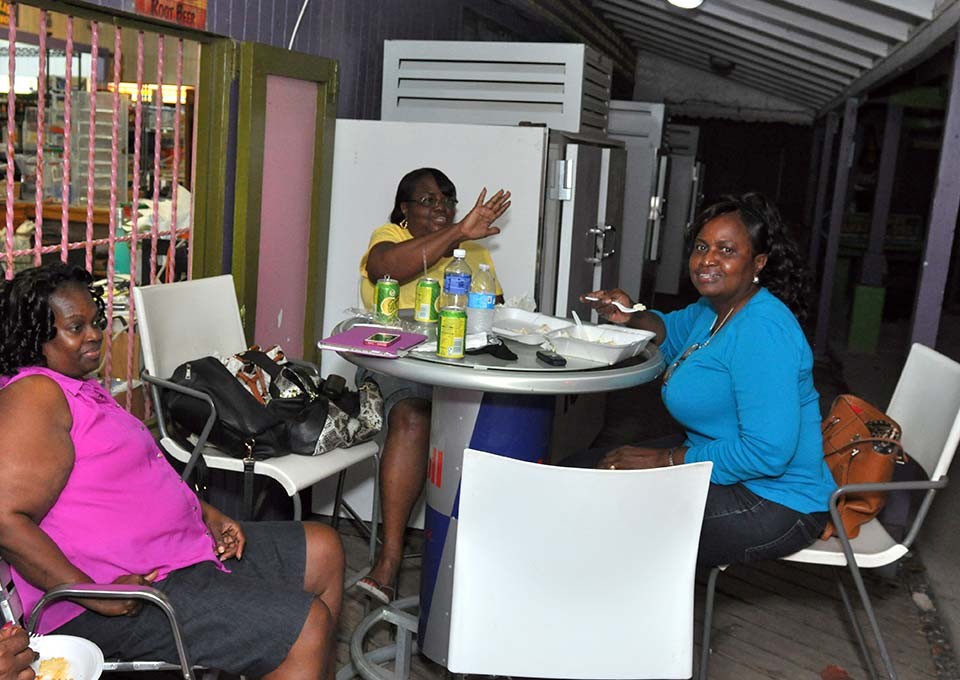 a group of locals enjoying their bbq at trellis bay market bvi