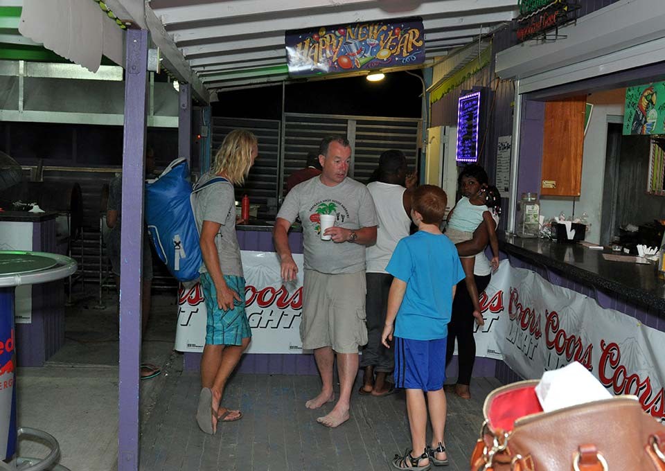 a group of happy customers waiting for their bbq at trellis bay full moon party