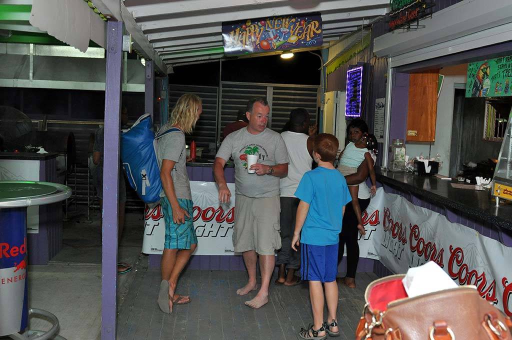 a group of happy customers waiting for their bbq at trellis bay full moon party