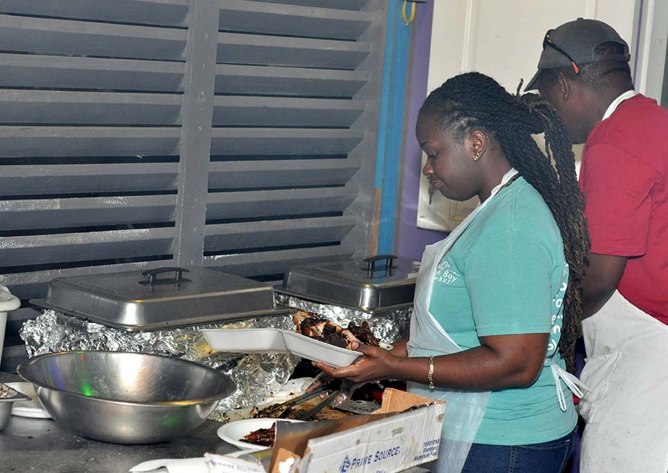 Chefs preparing jerk and BBQ dinner