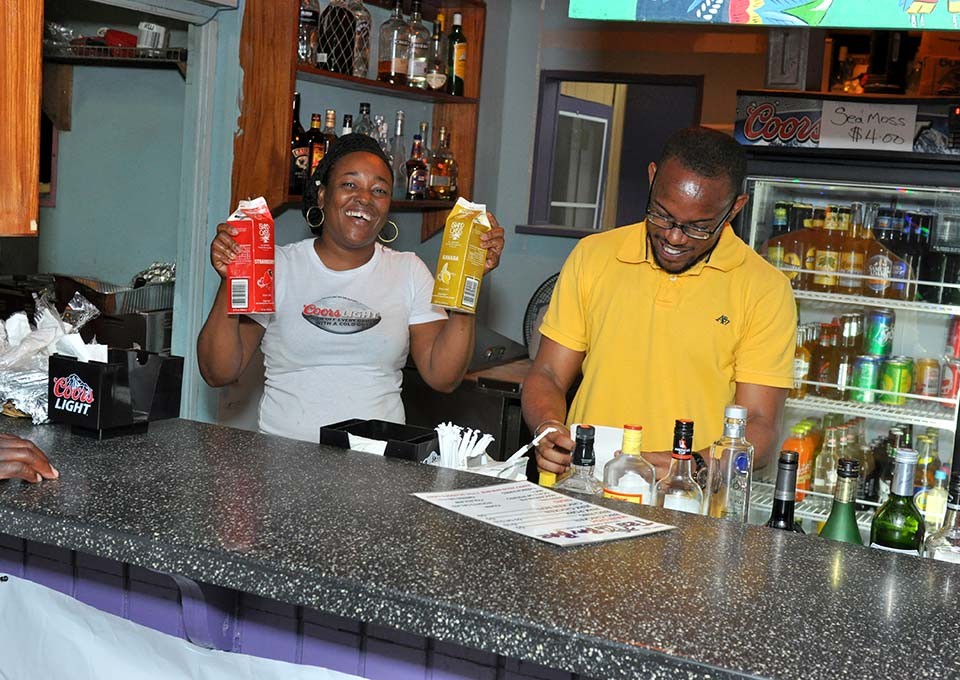 workers having some trellis bay fun behind the bar