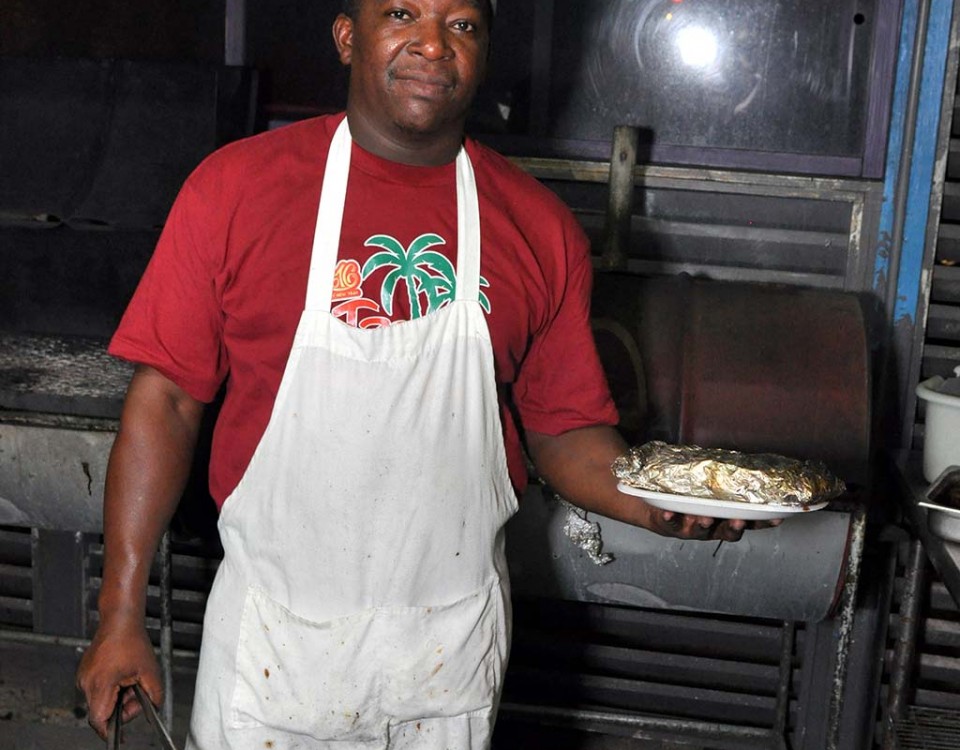 trellis bay market grill master serving grilled fish