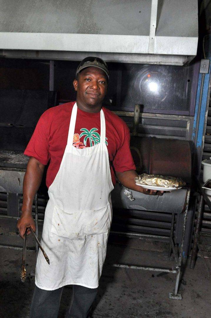 trellis bay market grill master serving grilled fish