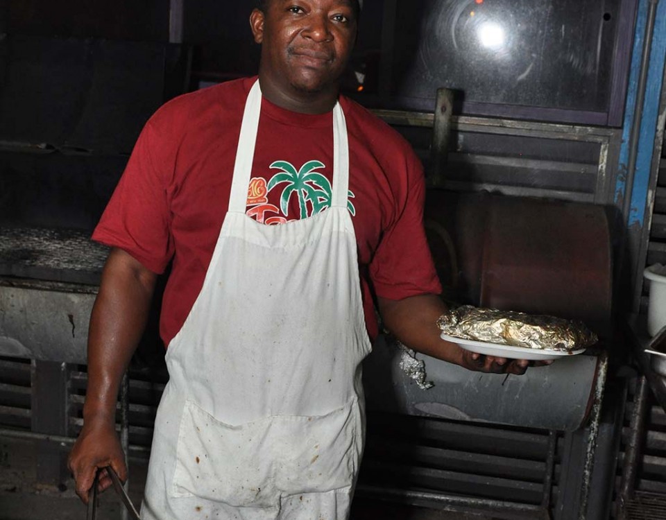 chef peter serving his grill fish fresh of the flaming grill