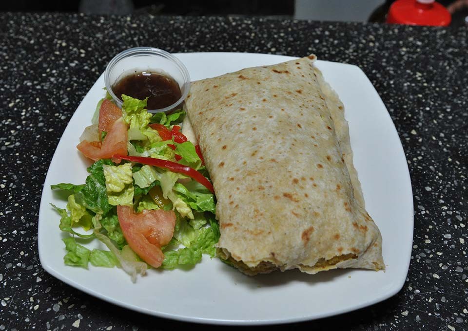 trellis bay market award winning chicken roti served with green salad and mango chutney