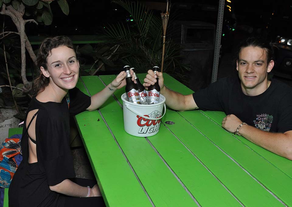 tourist enjoying coors lights buckets at trellis bay market