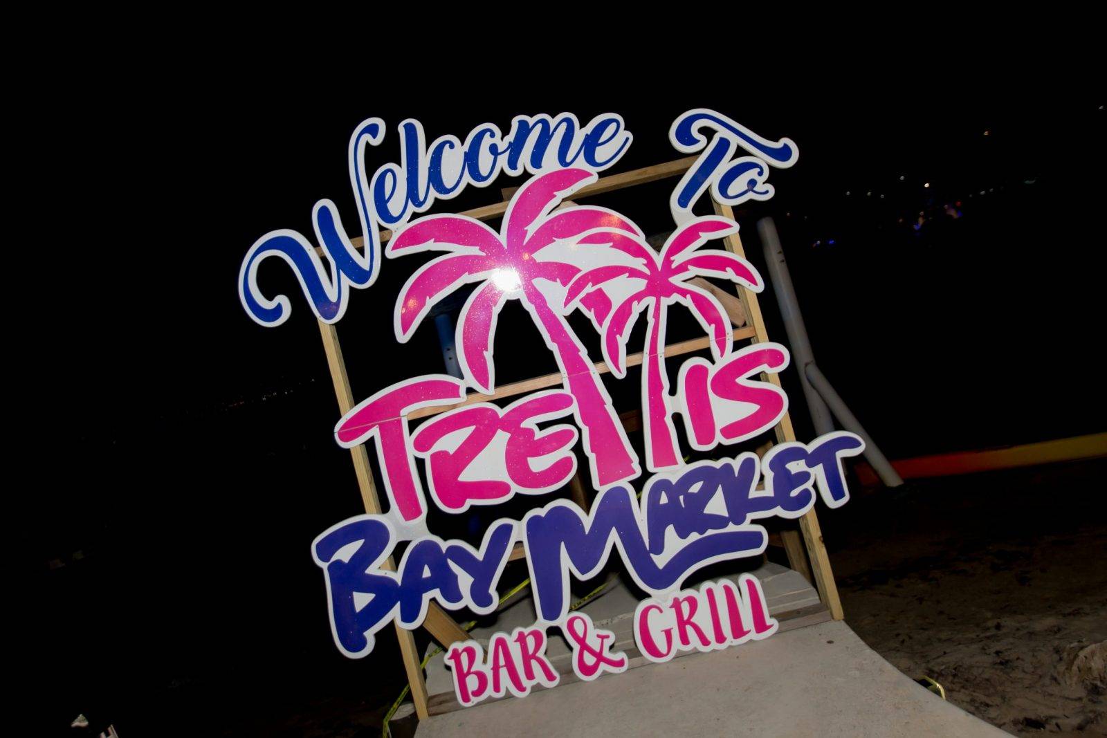 A welcome sign to the Trellis Bay Market Bar & Grill
