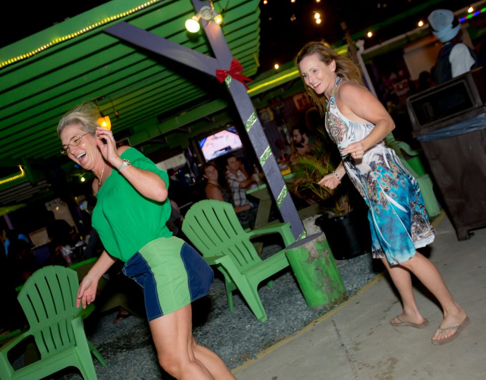 Two women dancing to the beat of the music