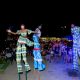 Three people on stilts doing their routine