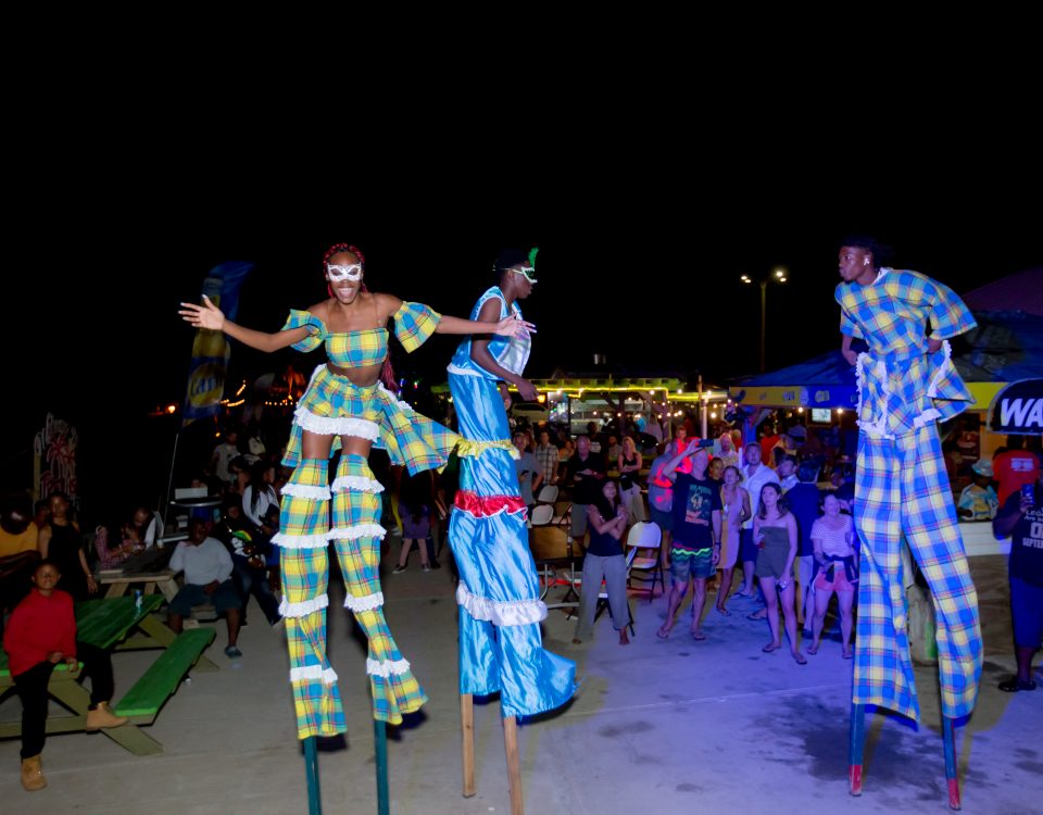 Three people on stilts doing their routine