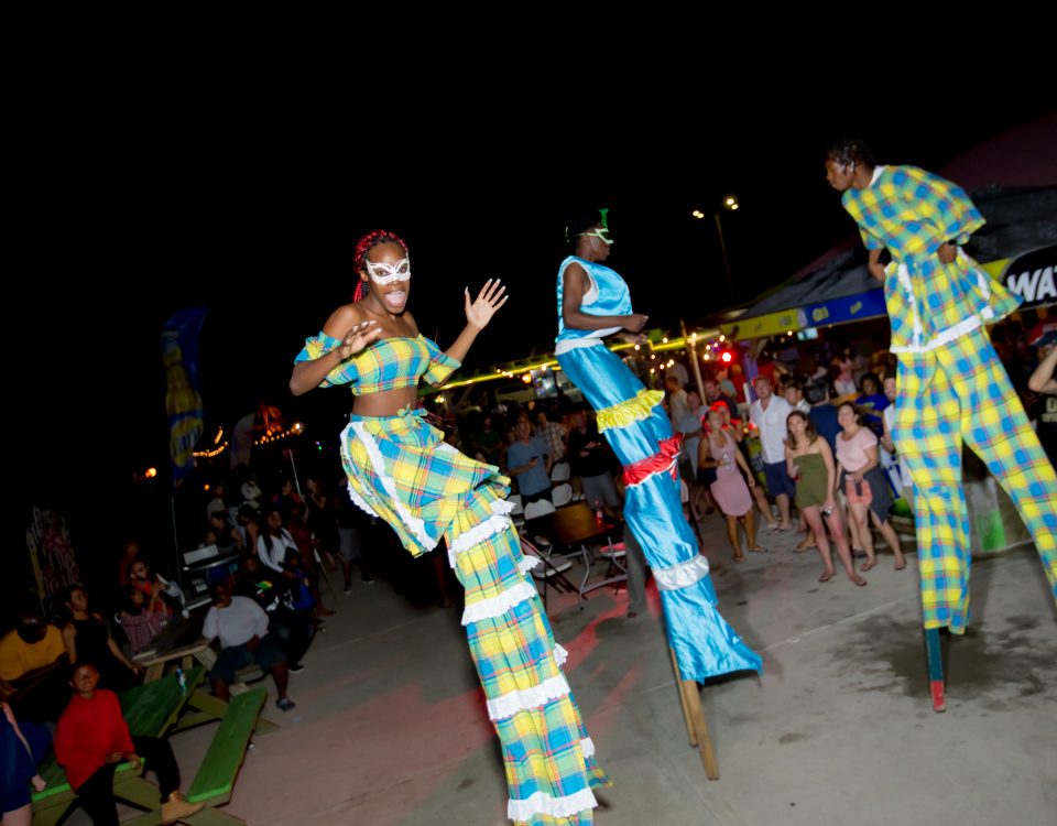 Three people performing on their stilts