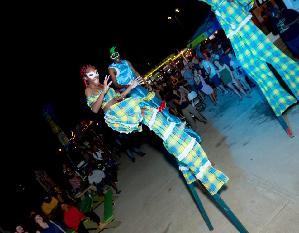 One of the stilts performers in her blue and yellow apparel