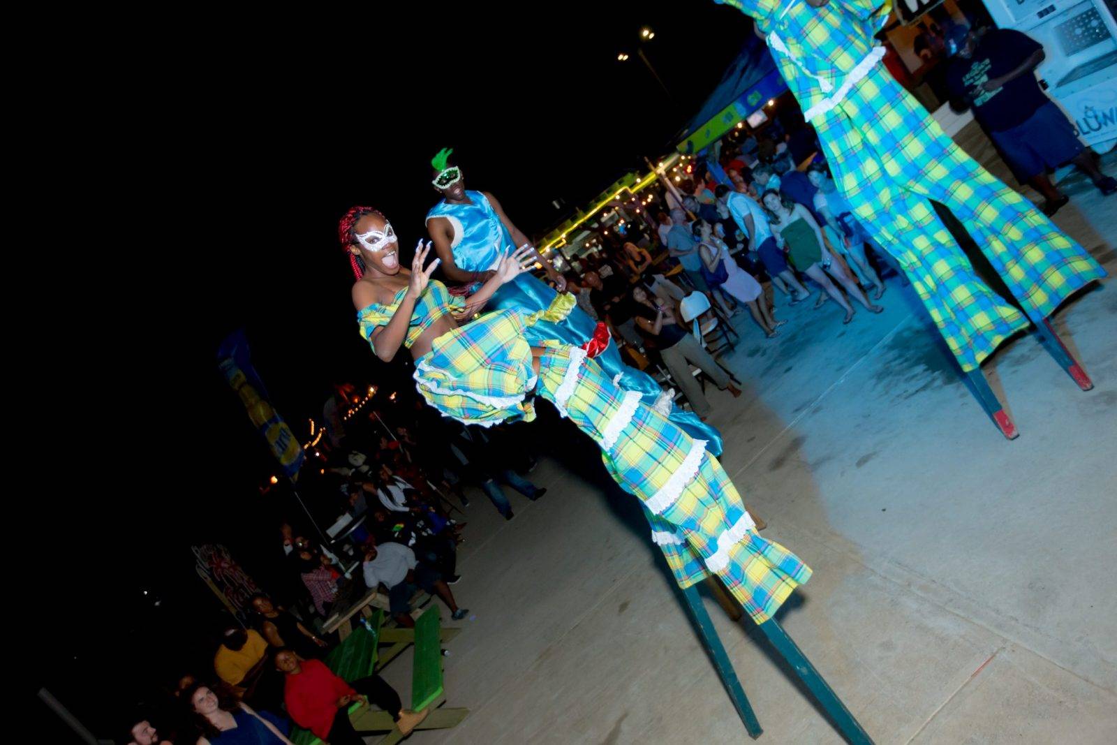One of the stilts performers in her blue and yellow apparel
