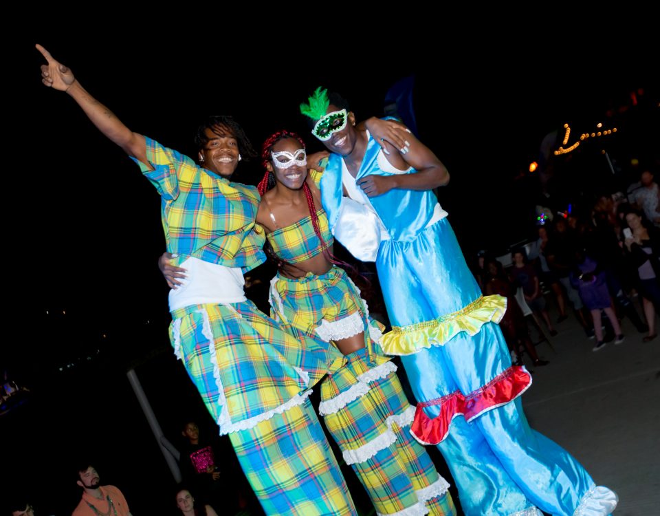 Three people in their stilts costume