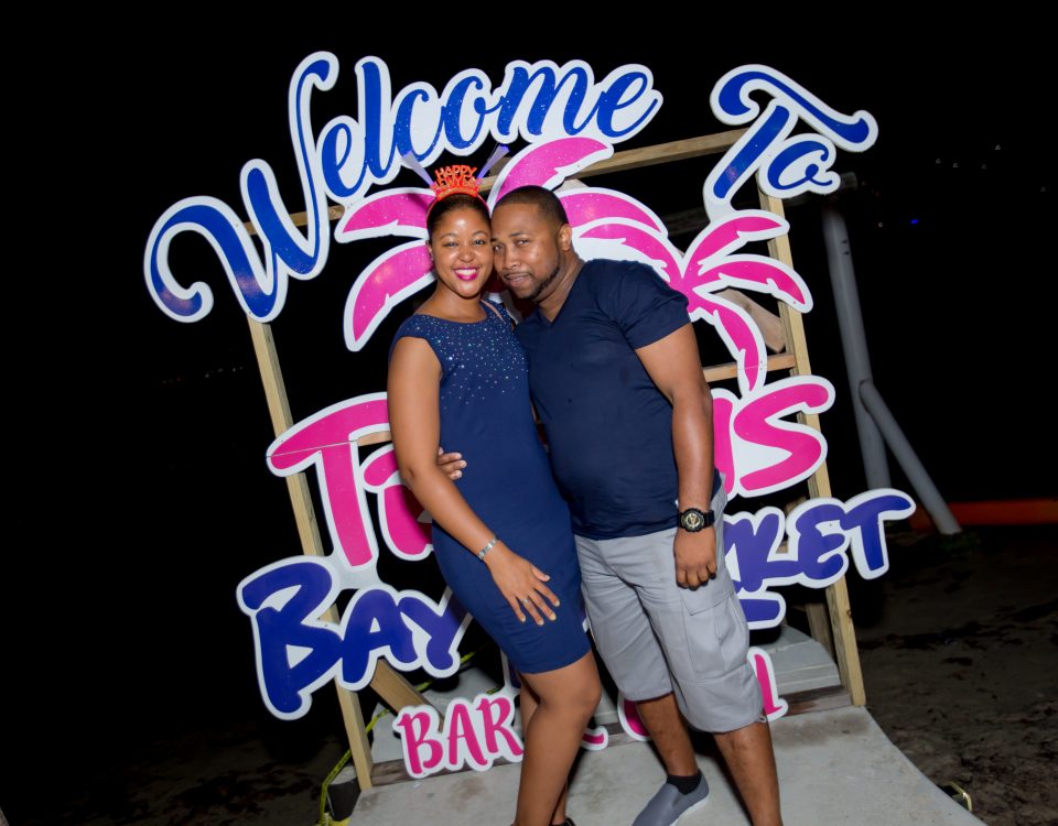 A couple standing in front of the welcome sign