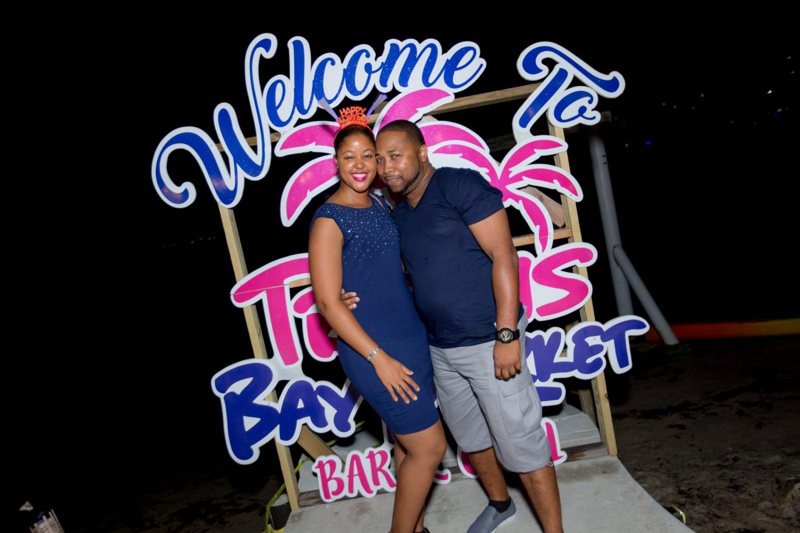 A couple standing in front of the welcome sign