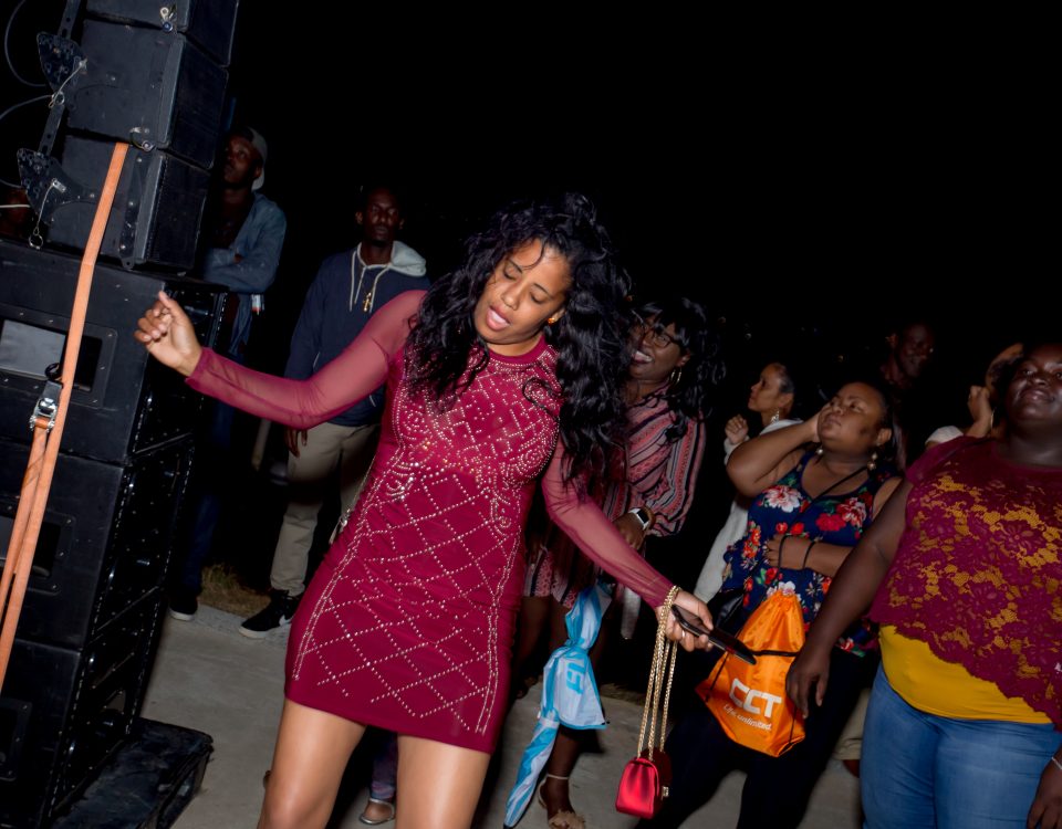 A woman in a red dress dancing