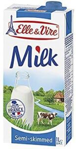 A milk carton with a countryside background and a glass milk bottle illustration.