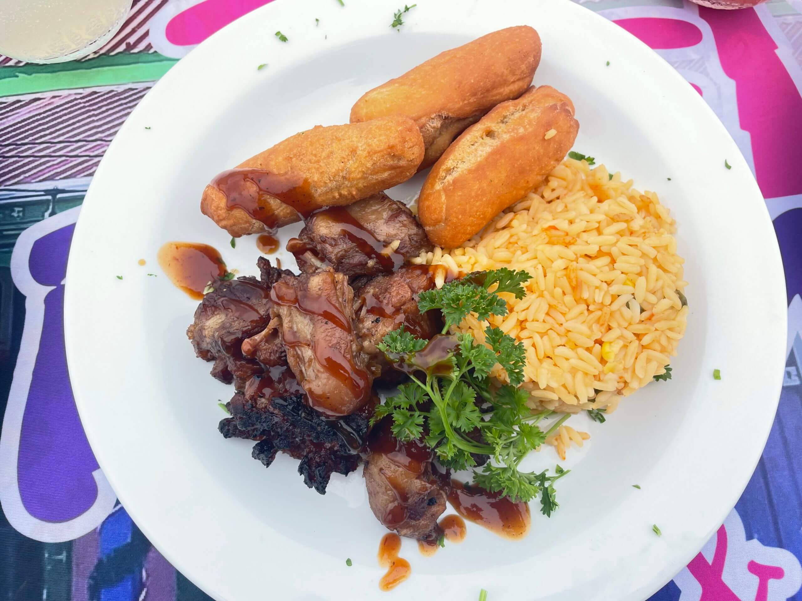 Plate of rice, meat, and fried rolls.