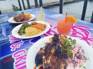 Grilled dishes with drinks by the water.