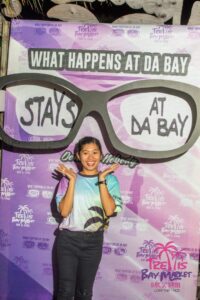 Person posing with large sunglasses display.